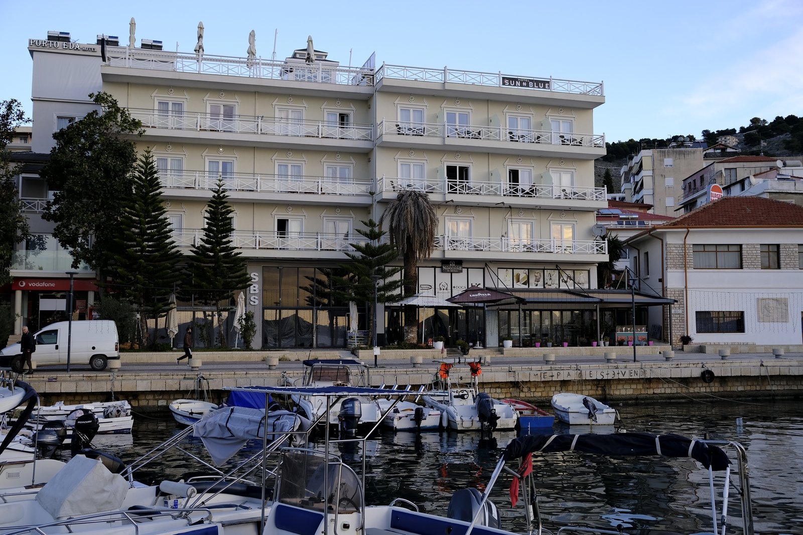 Sarandë marina with fishing boats and waterfront buildings